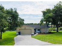 Charming single-story home with a well-maintained lawn and an attached garage at 8050 Roxburgh Ct, Weeki Wachee, FL 34613