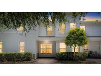 Charming two-story townhouse featuring a well-maintained front yard and a serene, inviting entrance at 9628 Charlesberg Dr, Tampa, FL 33635