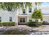 Charming two-story townhouse featuring a well-maintained front yard and a serene, inviting entrance at 9628 Charlesberg Dr, Tampa, FL 33635