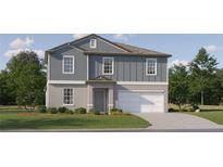 Charming two-story home with gray siding, a well-manicured lawn, and an attached two-car garage at 12609 Aura Moonlight Ter, Parrish, FL 34219