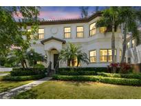 Stately two-story home featuring lush landscaping, manicured lawn, and a tile roof at 134 Chesapeake Ave, Tampa, FL 33606
