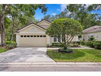 Charming home featuring a manicured front yard and a two-car garage at 15314 Sherwood Forest Dr, Tampa, FL 33647