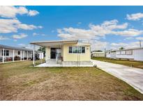 Inviting single-story home with a covered porch and well-maintained lawn at 36848 Beth Ave, Zephyrhills, FL 33542