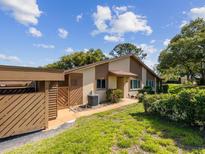 Charming one-story home featuring a well-manicured lawn, lush landscaping, and an attached carport at 4016 Lighthouse Way, New Port Richey, FL 34652