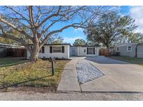 Charming single-story home with a well-maintained lawn and a concrete driveway at 6136 56Th N Ave, St Petersburg, FL 33709