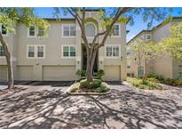 Charming townhouse with attached garages and mature landscaping in a desirable community with tree-lined streets at 728 Seagate Dr, Tampa, FL 33602