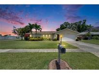 Charming single-story home featuring lush landscaping, a well-manicured lawn, and a classic mailbox at 12933 90Th Ave, Seminole, FL 33776