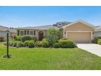 Well-maintained home featuring a lush lawn, mature landscaping, and inviting curb appeal at 2803 130Th E Ave, Parrish, FL 34219