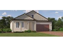 Charming one-story home with a brick driveway, neutral siding, well-manicured lawn and a two-car garage at 31793 Griffin Sands Ln, San Antonio, FL 33576