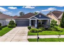 Charming single-story home featuring a well-manicured lawn and inviting curb appeal at 32628 Harmony Oaks Dr, Wesley Chapel, FL 33545