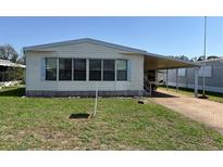 Charming single-story home with a covered carport and well-maintained lawn at 35804 Brisa Dr, Zephyrhills, FL 33541
