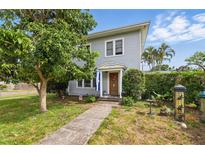 Charming home featuring a well-manicured lawn, sidewalk, mature trees, and a welcoming front door at 4100 1St S Ave, St Petersburg, FL 33711