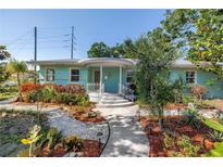Charming single-story home featuring a well-manicured front yard with lush landscaping and a welcoming walkway at 5051 5Th S Ave, St Petersburg, FL 33707