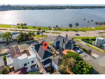 Stunning aerial view of waterfront home, with lush landscaping and a charming neighborhood at 723 S Brevard Ave, Tampa, FL 33606
