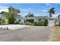 Charming single-story home with a gravel yard and colorful landscaping at 832 Seabreeze Dr, Ruskin, FL 33570