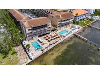 Waterfront condo community featuring two pools, patio dining, and beach access, providing a relaxing vacation spot at 1420 Bayshore Blvd # 409, Dunedin, FL 34698