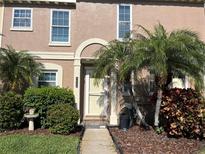 Charming townhome with a front porch and lush tropical landscaping at 1512 Chateaux De Ville Ct, Clearwater, FL 33764