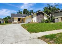 Charming single-story home with mixed siding, attached garage, and well-maintained lawn at 18426 Sterling Silver Cir, Lutz, FL 33549
