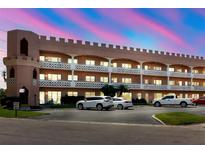 Unique three-story condo complex showcases castle-like design, white balconies, and ample parking at 2457 Ecuadorian Way # 63, Clearwater, FL 33763