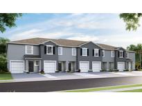 Newly constructed townhomes feature two-car garages, neutral paint, and nicely landscaped yard at 32429 Welling Blade Loop, Wesley Chapel, FL 33545