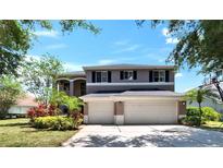 Two-story home featuring a three-car garage and well-maintained landscaping at 3314 Cypress Landing Dr, Valrico, FL 33596