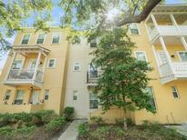 Inviting multi-story townhome featuring balconies and lush landscaping, offering a blend of comfort and curb appeal at 956 Sombra St, Tampa, FL 33619