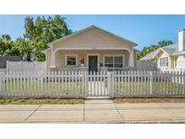 Charming single-story home with a welcoming front porch and a white picket fence at 1050 22Nd N Ave, St Petersburg, FL 33704