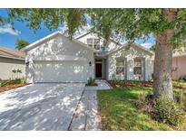 Charming single-story home with a well-manicured lawn and a two car garage at 12351 Ridgedale Dr, Hudson, FL 34669