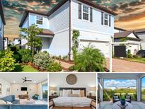 Beautiful two-story home featuring blue siding, well-manicured landscaping, and an attached two-car garage at 18172 Ramble On Way, Land O Lakes, FL 34638