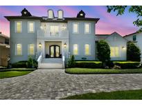Stately two-story home features a brick driveway, manicured landscaping, and a welcoming front entrance at 2604 S Bryant Cir, Tampa, FL 33629