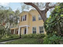 Inviting yellow two-story home with mature trees and meticulously maintained landscaping at 316 5Th N Ave, Safety Harbor, FL 34695