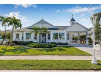Charming single-story home with a well-manicured lawn and palm trees accenting the front yard at 4612 Barracuda Dr, Bradenton, FL 34208