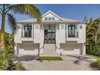 Stunning two-story home with a clean white facade, multi-car garage, and landscaped front yard at 721 Brightwaters Ne Blvd, St Petersburg, FL 33704