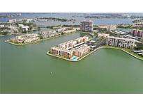 Waterfront condos surrounded by water with a community pool, boat docks and assigned parking at 7645 Sun Island S Dr # 207, South Pasadena, FL 33707