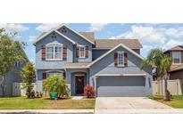 Charming two-story home with a well-manicured lawn, beautiful exterior paint and a spacious two-car garage at 11938 Bahia Valley Dr, Riverview, FL 33579