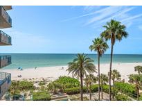 Beautiful beach view with palm trees and clear skies, offering a serene and tropical backdrop at 1520 Gulf Blvd # 404, Clearwater, FL 33767