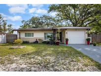 Charming one-story home with a well-manicured lawn and attached one car garage at 2167 Euclid E Cir, Clearwater, FL 33764