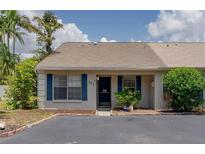 Inviting single-story home featuring blue shutters, a cozy front entrance, and well-maintained landscaping at 333 Bay Pl, Safety Harbor, FL 34695