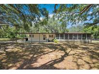 Traditional single-story home featuring a covered carport and Florida room at 34125 Chancey Rd, Wesley Chapel, FL 33543