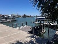 Waterfront property featuring a private boat dock and tranquil views of the waterway at 510 64Th Ave, St Pete Beach, FL 33706