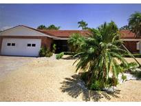 Charming single-story brick home with well-maintained landscaping and attached two-car garage at 510 64Th Ave, St Pete Beach, FL 33706