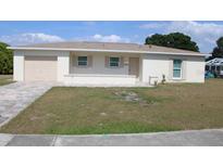 Charming single-story home with a well-maintained lawn and neutral-colored exterior at 7319 Holiday Dr, Spring Hill, FL 34606