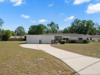 Charming single-story home featuring an attached two-car garage and a spacious driveway at 7346 Hiawatha Pkwy, Spring Hill, FL 34606