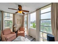 Cozy seating area featuring large windows with waterfront views and a ceiling fan at 7400 Sun Island S Dr # 206, South Pasadena, FL 33707