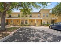 Charming townhome featuring a colorful exterior and well-maintained landscaping with convenient parking spaces at 3437 Dragon View Ct, Valrico, FL 33594