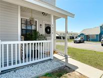 Charming front porch with white railing, decorative plants, and a welcoming entrance at 5316 Ladywell Ct, Tampa, FL 33624