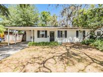 Charming one-story home with a covered front porch and beautiful landscaping at 7603 N 53Rd St, Tampa, FL 33617