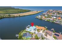 Waterfront home with lush landscaping, private dock, and stunning views of the bay and surrounding area at 935 Chipaway Dr, Apollo Beach, FL 33572