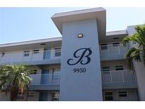 Exterior view of a condominium building with a large 'B' and the address 9950 displayed at 9950 47Th N Ave # 311, St Petersburg, FL 33708