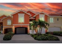 Inviting townhome featuring a private garage, beautiful landscaping, and elegant architectural details at 11 Franklin S Ct # C, St Petersburg, FL 33711